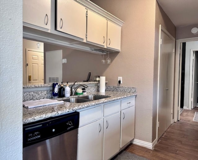 2211 S Kirkwood Rd Unit 35, Houston, TX 77077 - kitchen with dishwasher, dark wood-style flooring, and light stone counters