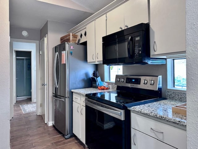 2211 S Kirkwood Rd Unit 35, Houston, TX 77077 - kitchen with stainless steel electric range, black microwave, dark wood-type flooring, and healthy amount of natural light