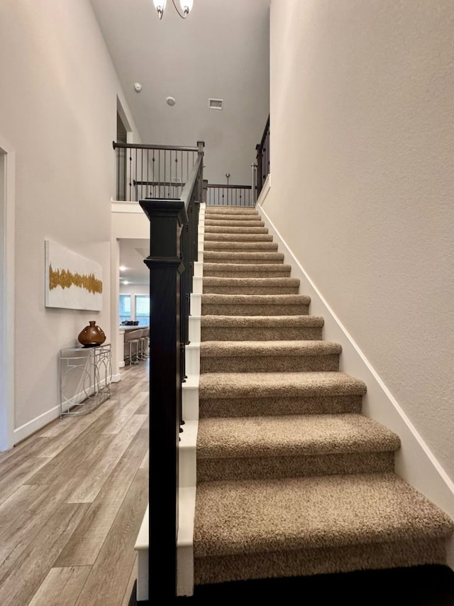 15814 Weston Ridge Dr, Humble, TX 77346 - staircase featuring wood finished floors and a towering ceiling