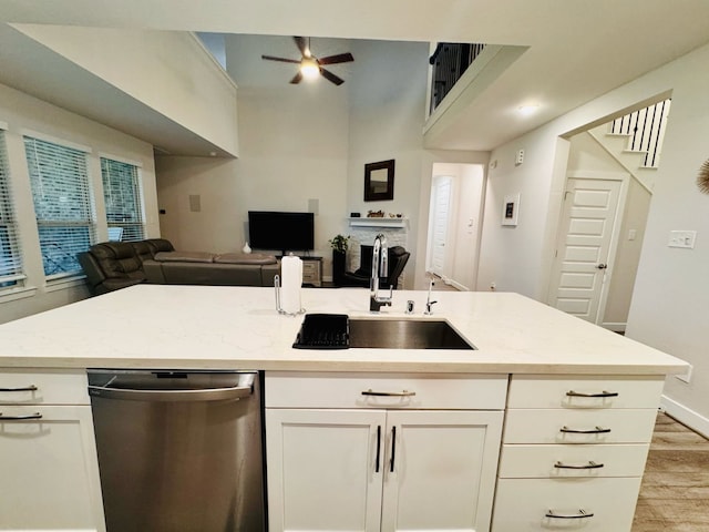 15814 Weston Ridge Dr, Humble, TX 77346 - kitchen with open floor plan, dishwasher, ceiling fan, light wood-style floors, and white cabinetry