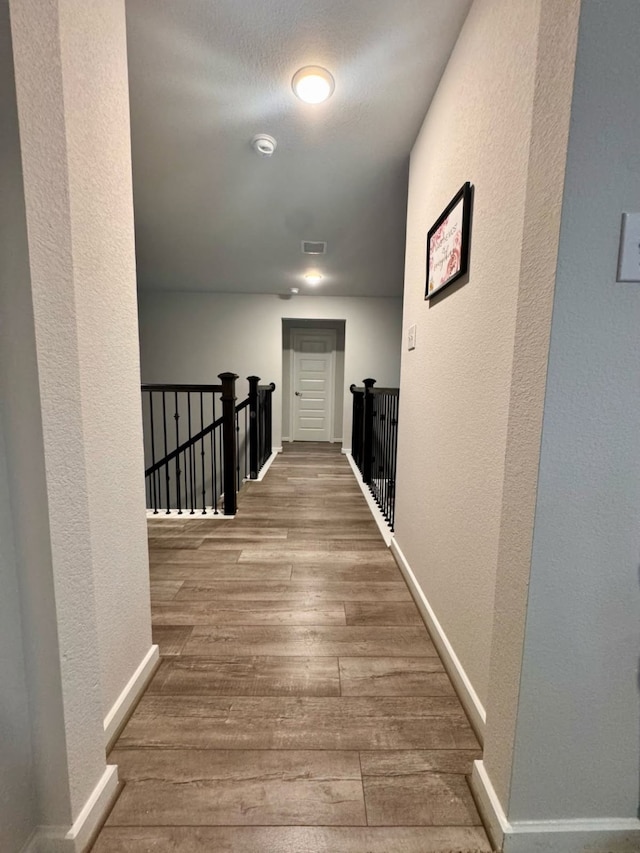 15814 Weston Ridge Dr, Humble, TX 77346 - hall featuring an upstairs landing, a textured wall, and wood finished floors