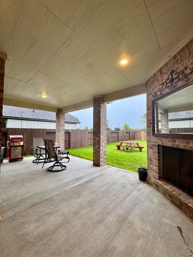 15814 Weston Ridge Dr, Humble, TX 77346 - fenced backyard featuring a patio and an outdoor brick fireplace