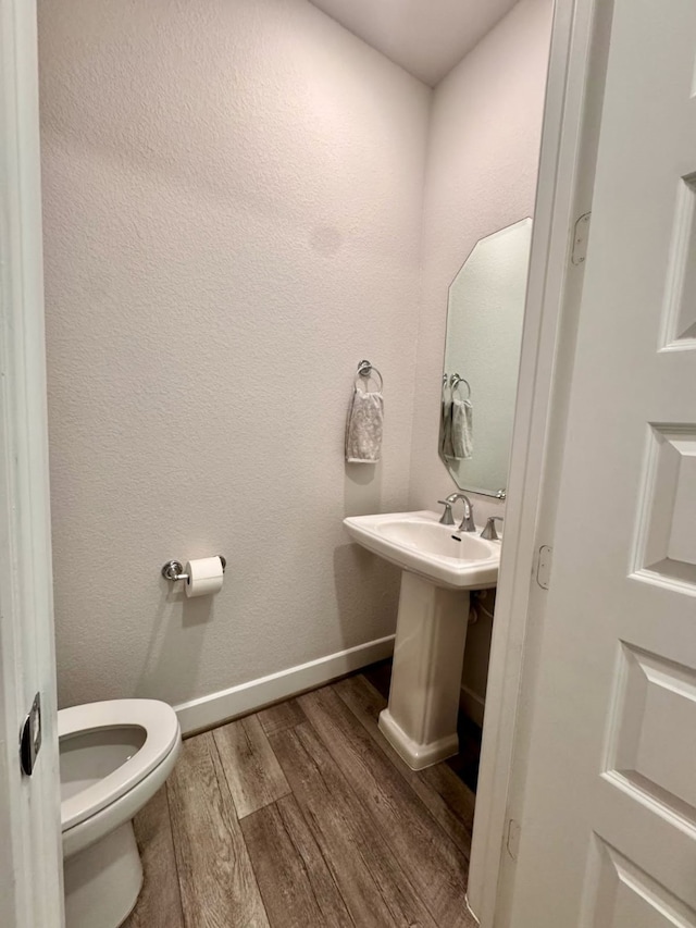 15814 Weston Ridge Dr, Humble, TX 77346 - half bathroom with wood finished floors and toilet