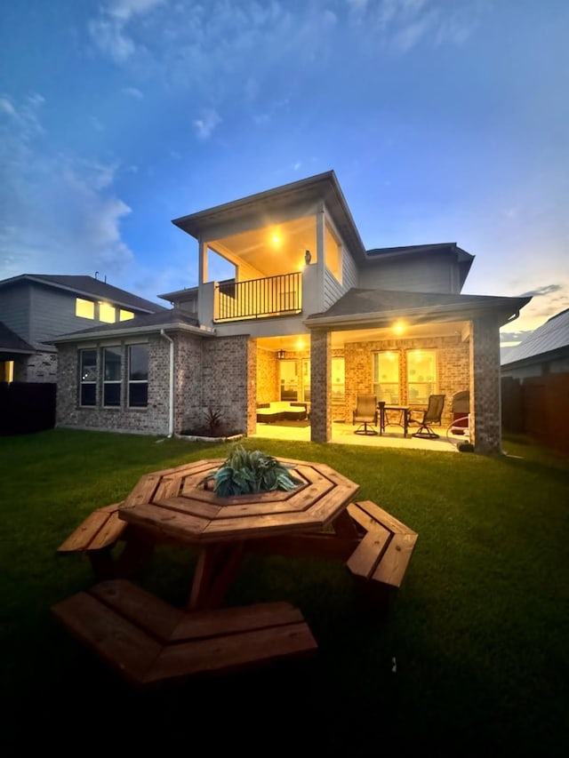 15814 Weston Ridge Dr, Humble, TX 77346 - back of house featuring a balcony, brick siding, an outdoor fire pit, and a patio
