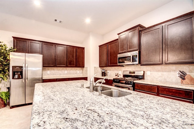 12223 Antilles Ln, Conroe, TX 77304 - kitchen with stainless steel appliances, light stone counters, backsplash, and recessed lighting