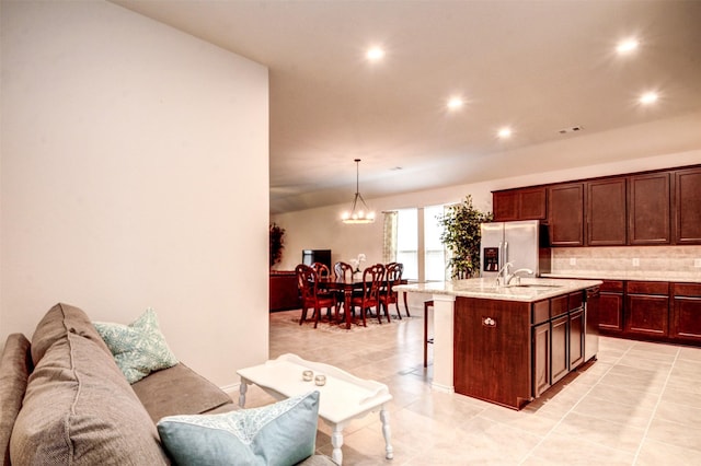 12223 Antilles Ln, Conroe, TX 77304 - kitchen with a kitchen breakfast bar, recessed lighting, backsplash, a chandelier, and a kitchen island with sink