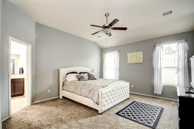 12223 Antilles Ln, Conroe, TX 77304 - carpeted bedroom with multiple windows, lofted ceiling, connected bathroom, and ceiling fan