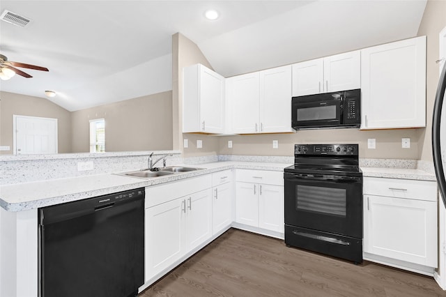 638 E Fairway Lake Dr, Alvin, TX 77511 - kitchen with vaulted ceiling, black appliances, ceiling fan, a peninsula, and white cabinets