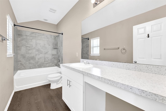 638 E Fairway Lake Dr, Alvin, TX 77511 - bathroom featuring wood finished floors, vanity, washtub / shower combination, and lofted ceiling