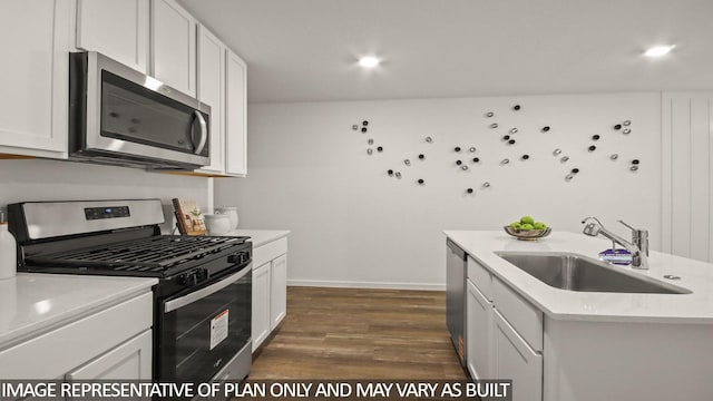 23748 Patchouli Terrace Dr, Splendora, TX 77372 - kitchen featuring stainless steel appliances, dark wood-style flooring, light countertops, white cabinets, and recessed lighting