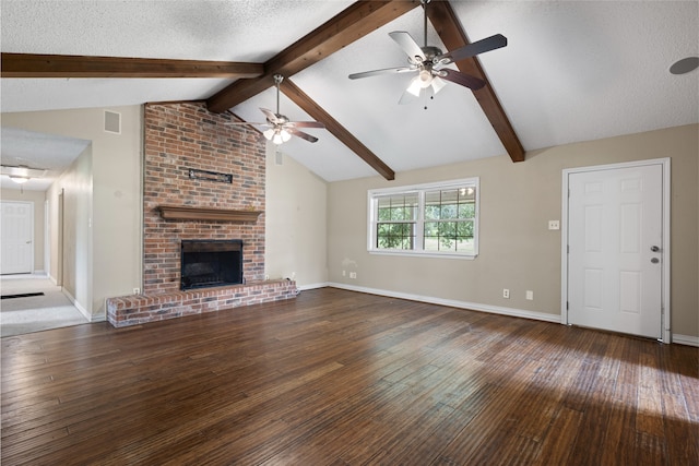 27093 Frye Rd, Splendora, TX 77372 - unfurnished living room featuring ceiling fan, wood-type flooring, and a brick fireplace
