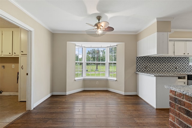 27093 Frye Rd, Splendora, TX 77372 - unfurnished dining area with a ceiling fan, dark wood-style flooring, and crown molding
