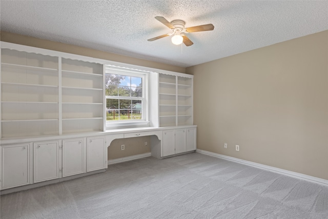 27093 Frye Rd, Splendora, TX 77372 - unfurnished office with ceiling fan, light carpet, a textured ceiling, and built in study area