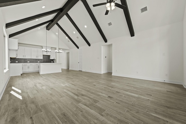 16710 Yaklin Meadow Ct, Humble, TX 77346 - unfurnished living room with a chandelier, high vaulted ceiling, a ceiling fan, recessed lighting, and beam ceiling