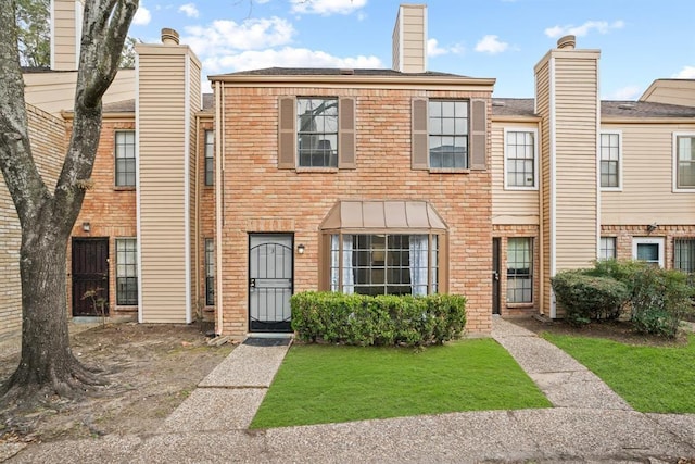 9901 Sharpcrest St Unit K-3, Houston, TX 77036 - view of front of home with brick siding, a front lawn, and a shingled roof