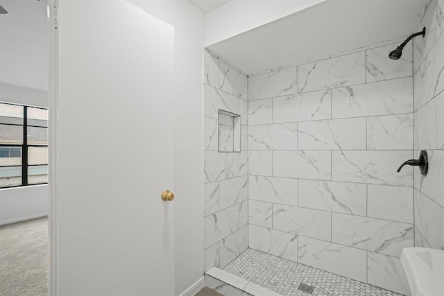9901 Sharpcrest St Unit K-3, Houston, TX 77036 - bathroom featuring tiled shower and baseboards