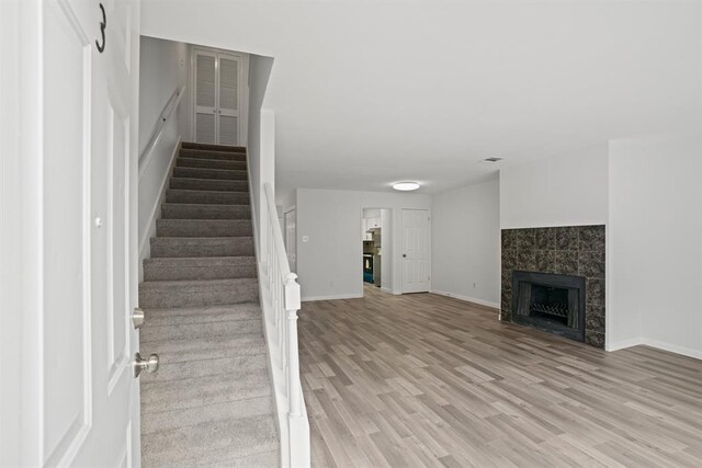 9901 Sharpcrest St Unit K-3, Houston, TX 77036 - staircase featuring wood finished floors and a tiled fireplace