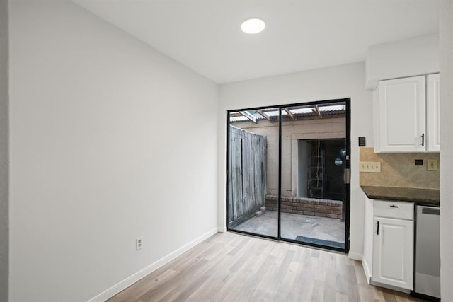 9901 Sharpcrest St Unit K-3, Houston, TX 77036 - unfurnished dining area with light wood-style flooring and baseboards