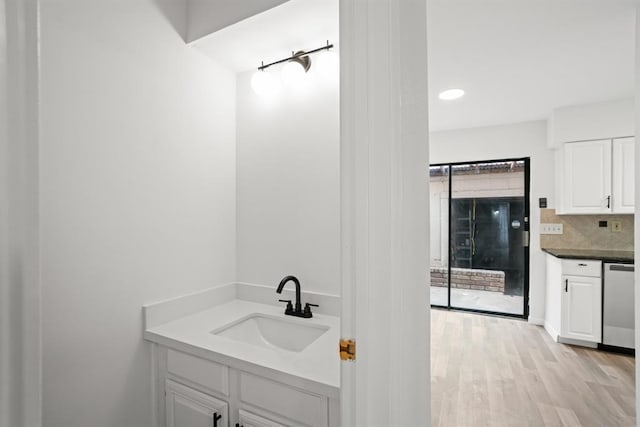 9901 Sharpcrest St Unit K-3, Houston, TX 77036 - bathroom featuring wood finished floors and tasteful backsplash