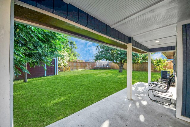 743 Eastlake St, Houston, TX 77034 - fenced backyard with a trampoline, a patio, and an outdoor structure