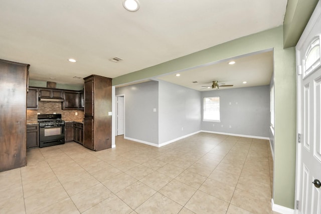 743 Eastlake St, Houston, TX 77034 - kitchen featuring dark brown cabinets, black gas range oven, decorative backsplash, light tile patterned floors, and a ceiling fan