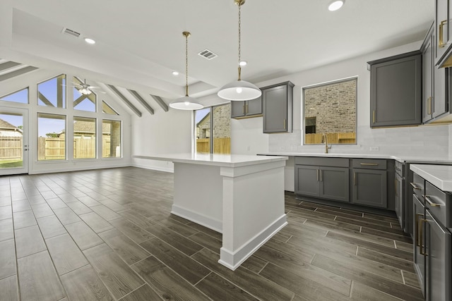 16738 Yaklin Meadow Ct, Humble, TX 77346 - kitchen with gray cabinets, tasteful backsplash, wood finish floors, a ceiling fan, and recessed lighting