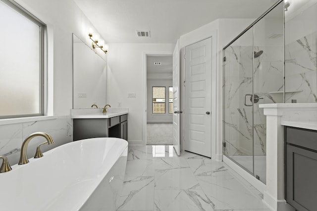 16738 Yaklin Meadow Ct, Humble, TX 77346 - bathroom featuring vanity, a marble finish shower, a soaking tub, and marble finish flooring