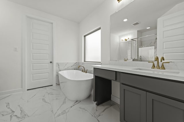 16738 Yaklin Meadow Ct, Humble, TX 77346 - bathroom featuring vanity, a freestanding bath, a marble finish shower, marble look tiles, and recessed lighting