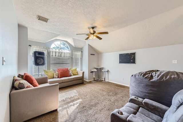 16307 Mango Ridge Ct, Humble, TX 77396 - carpeted living room featuring vaulted ceiling, a ceiling fan, and a textured ceiling
