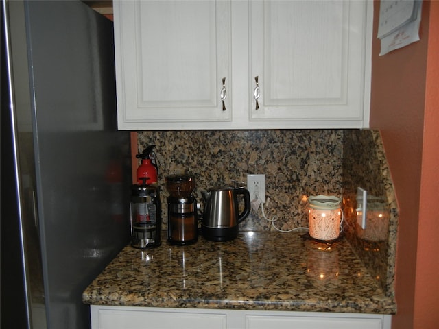 4822 Edgegate Dr, Spring, TX 77373 - kitchen featuring freestanding refrigerator, backsplash, white cabinetry, and dark stone counters