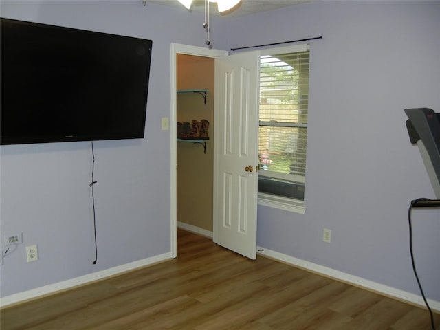 4822 Edgegate Dr, Spring, TX 77373 - unfurnished bedroom featuring wood finished floors and a walk in closet