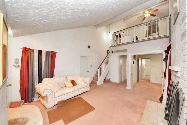 15147 Sheffield Ter, Channelview, TX 77530 - living area featuring a fireplace, a textured ceiling, stairway, ceiling fan, and lofted ceiling
