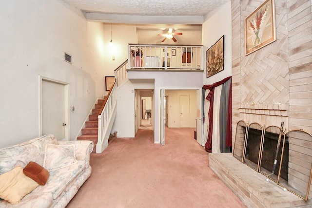 15147 Sheffield Ter, Channelview, TX 77530 - living room with carpet floors, stairs, a towering ceiling, a brick fireplace, and ceiling fan