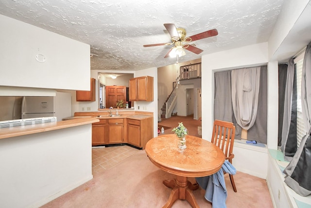 15147 Sheffield Ter, Channelview, TX 77530 - dining area with stairway, a ceiling fan, light carpet, and a textured ceiling
