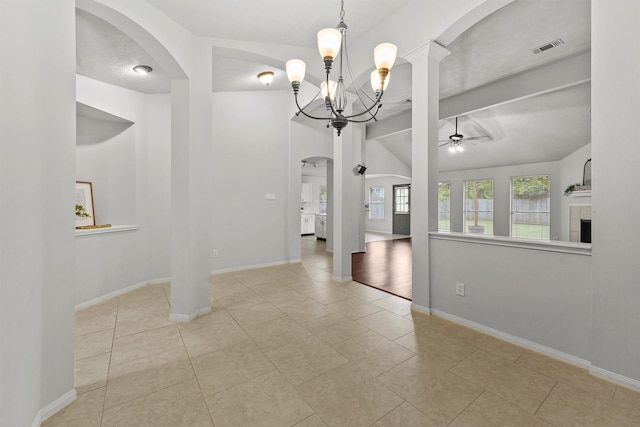 21327 Hadrian Dr, Katy, TX 77449 - tiled spare room with arched walkways, ceiling fan, a chandelier, and a tile fireplace