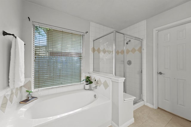 21327 Hadrian Dr, Katy, TX 77449 - full bathroom featuring a garden tub, a shower stall, and tile patterned flooring
