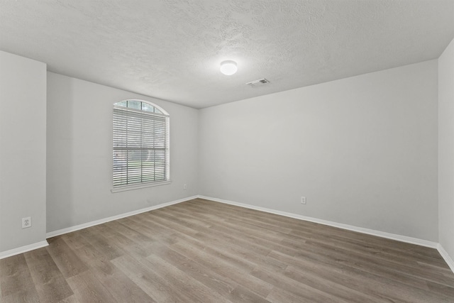 21327 Hadrian Dr, Katy, TX 77449 - empty room featuring wood finished floors and a textured ceiling