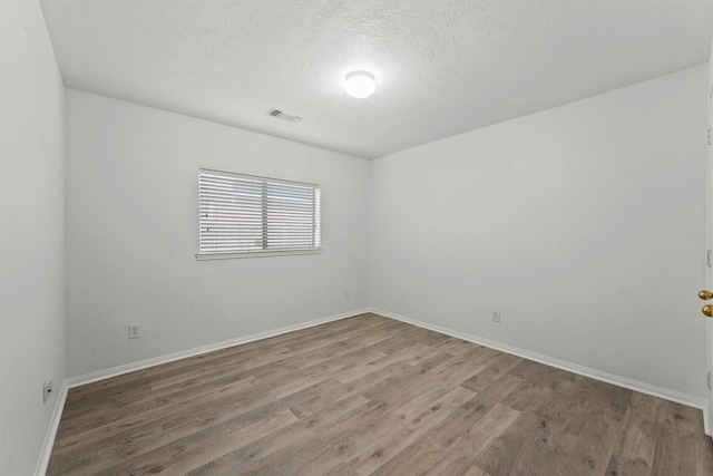 21327 Hadrian Dr, Katy, TX 77449 - empty room with wood finished floors and a textured ceiling