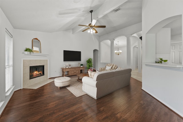 21327 Hadrian Dr, Katy, TX 77449 - living area featuring a tiled fireplace, ceiling fan, healthy amount of natural light, and wood finished floors