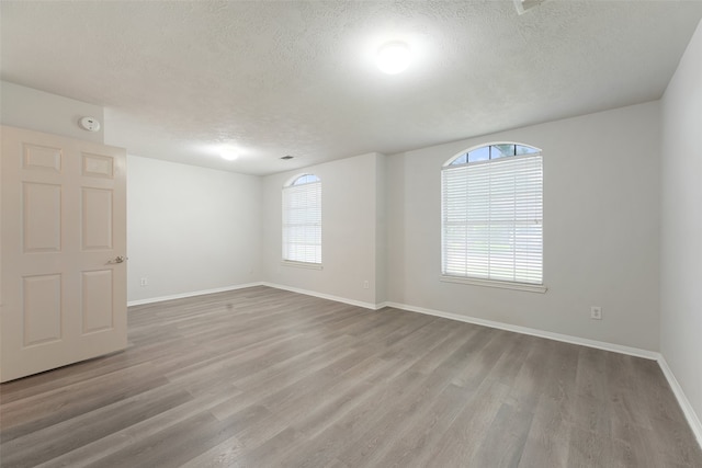 21327 Hadrian Dr, Katy, TX 77449 - spare room with a textured ceiling and wood finished floors