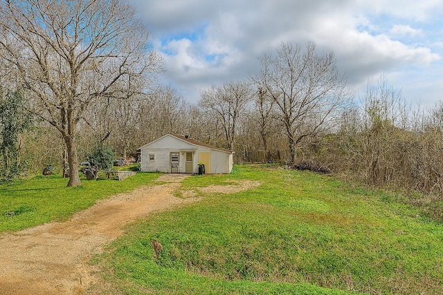 11805 S Garden St, Houston, TX 77071 - view of grassy yard with driveway and an outbuilding
