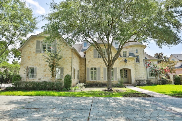 764 Kuhlman Rd, Hunters Creek Village, TX 77024 - french country home featuring stone siding