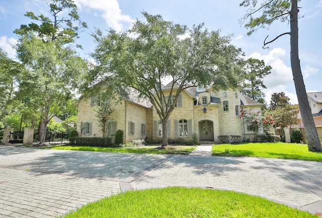 764 Kuhlman Rd, Hunters Creek Village, TX 77024 - french provincial home featuring stone siding, french doors, and a front yard