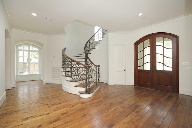 764 Kuhlman Rd, Hunters Creek Village, TX 77024 - entryway featuring arched walkways, french doors, hardwood / wood-style floors, crown molding, and stairway