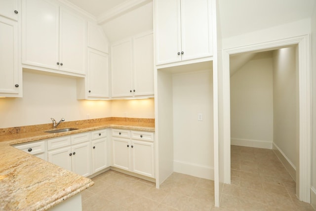 764 Kuhlman Rd, Hunters Creek Village, TX 77024 - kitchen with white cabinets, light tile patterned flooring, and light stone counters