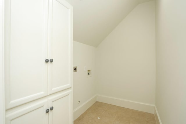 764 Kuhlman Rd, Hunters Creek Village, TX 77024 - washroom featuring hookup for an electric dryer, hookup for a washing machine, cabinet space, and light tile patterned floors