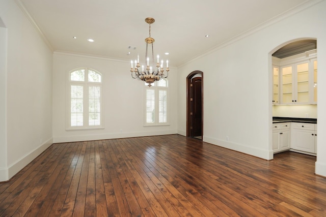 764 Kuhlman Rd, Hunters Creek Village, TX 77024 - empty room featuring a chandelier, arched walkways, dark wood-style floors, ornamental molding, and recessed lighting