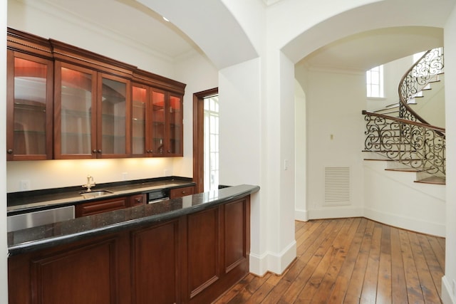 764 Kuhlman Rd, Hunters Creek Village, TX 77024 - indoor wet bar with arched walkways, ornamental molding, stairs, dark wood-type flooring, and dishwasher