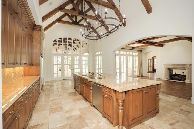 764 Kuhlman Rd, Hunters Creek Village, TX 77024 - kitchen with beamed ceiling, arched walkways, open floor plan, brown cabinets, and backsplash