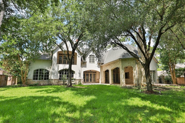 764 Kuhlman Rd, Hunters Creek Village, TX 77024 - back of property featuring french doors, stucco siding, stone siding, and a shingled roof